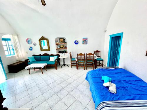 a bedroom with a bed and a living room at Sunset Queen in Oia in Oia