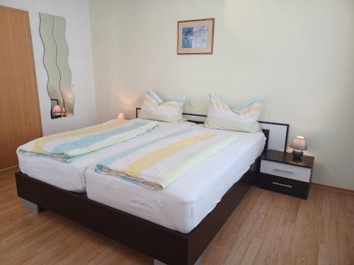 1 dormitorio con 1 cama blanca grande con almohadas en Ferienhaus Langenhecke 18, en Bad Münstereifel