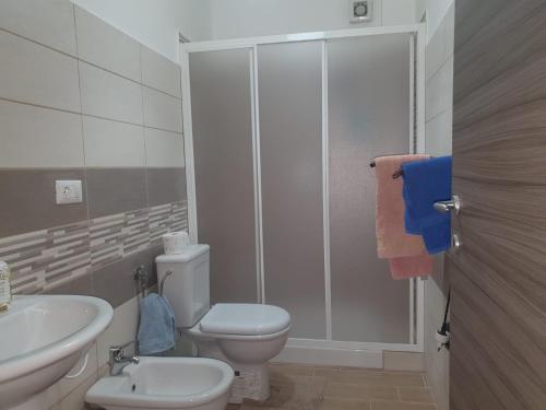 a bathroom with a toilet and a sink and a shower at Nancy Casa vacanze in Nizza di Sicilia