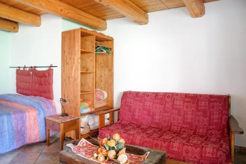 a living room with a couch and a bed at Genzianella Tano di Grich in Cesani