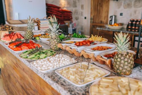 a buffet with many plates of food on a table at Cappadocia Vita Cave Hotel in Urgup