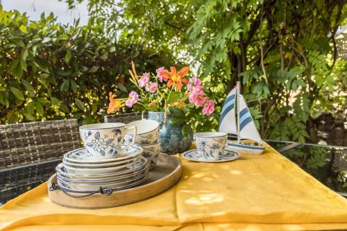 a table with plates and cups on a yellow table cloth at Haus Auryn in Markelfingen