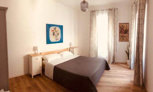 a bedroom with a bed and a window at Lilli's Home in Ascoli Piceno