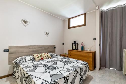 Un dormitorio con una cama en blanco y negro y una ventana en Casa Cattaleya, en Desenzano del Garda