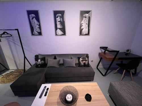 a living room with a couch and a table at VIP Apt. Pezodromos Kalamarias in Thessaloniki