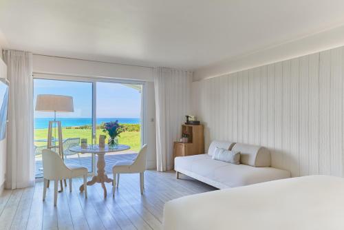 a hotel room with a bed and a table with a view at Villa L'Arche in Bidart