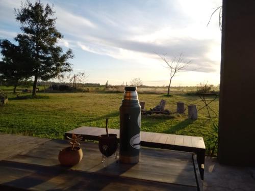 a bottle of beer sitting on a table with a drink at Casa rústica in San Pedro