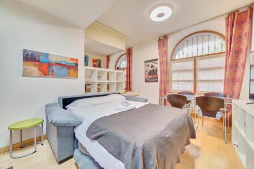 a bedroom with a bed and a table and chairs at Apartamento la Laurel by Clabao in Logroño