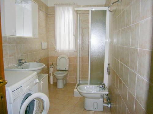 a bathroom with a toilet and a sink and a shower at Villaggio dei Fiori - Agenzia Cocal in Caorle