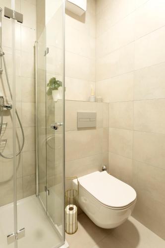 a bathroom with a toilet and a glass shower at Apartman Elena Ekolu in Split