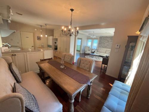 a kitchen and living room with a wooden table and chairs at Maccha House Near Zenkoji Nagano in Nagano