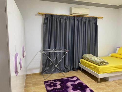 a room with a bed and a window with a curtain at Amwaj Compound in Hurghada