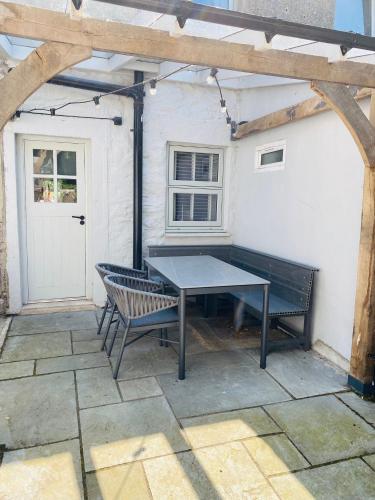 a table and two chairs on a patio at Emelia Cottage Ingleton in Ingleton 