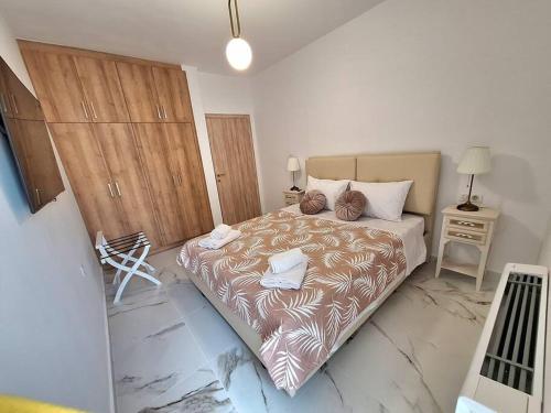a bedroom with a large bed in a room at Corfu Airport Sweet Home in Agios Rokkos