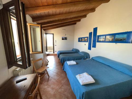 a living room with two beds and a couch at Dimora Tipica in Marsala