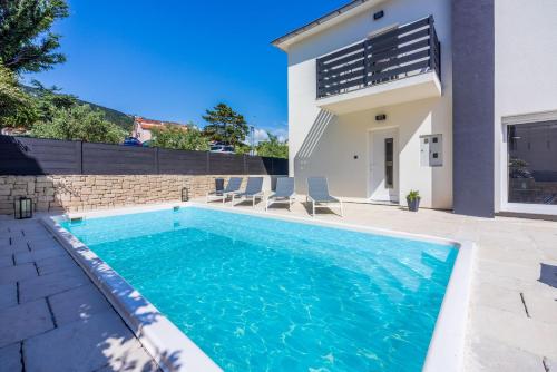 una piscina frente a una casa en Villa BAŠKA near the beach, en Baška