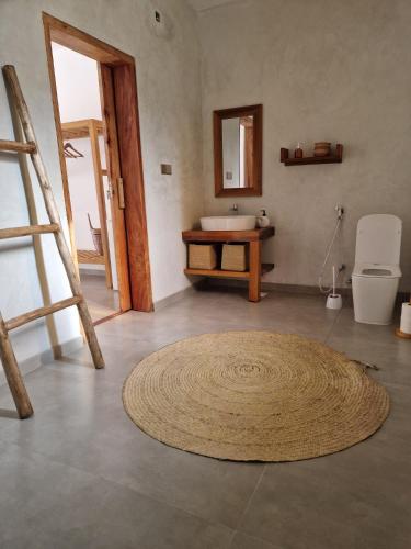 a bathroom with a sink and a rug on the floor at Sunny Villa Matemwe in Matemwe