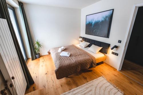 a bedroom with a bed and a large window at Apartmán Místo Na Vzduchu in Železná Ruda