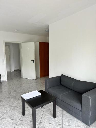 a living room with a couch and a coffee table at Pension Seckbach in Frankfurt/Main