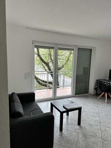 a living room with a couch and a coffee table at Pension Seckbach in Frankfurt/Main