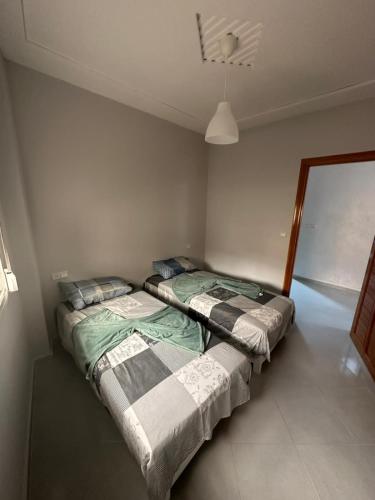 Postel nebo postele na pokoji v ubytování SAIDIA COSY FLAT