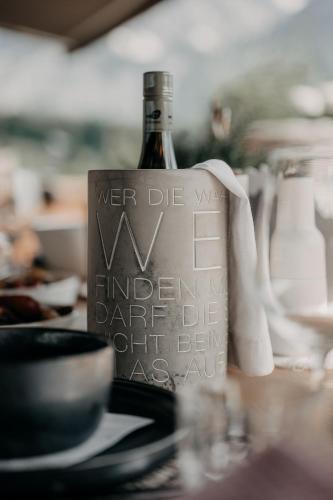 a bottle of wine sitting on top of a table at Alpenappartements Cristall in Ehrwald