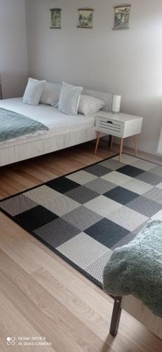 a living room with a bed and a table at Guest house Dagovic in Bajina Bašta