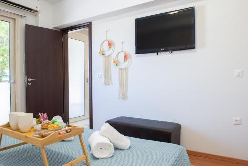 a room with a bed and a table with a tv at Charavgi apartment 2 in Kremasti