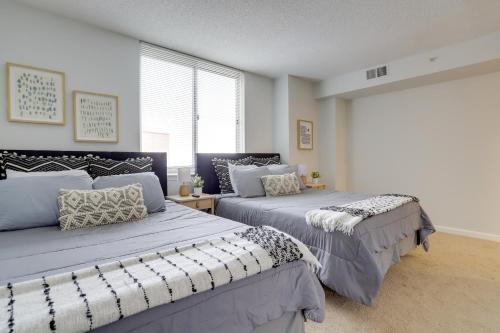 a bedroom with two beds and a window at Elegant and Charming Condo at Ballston with Pool in Arlington