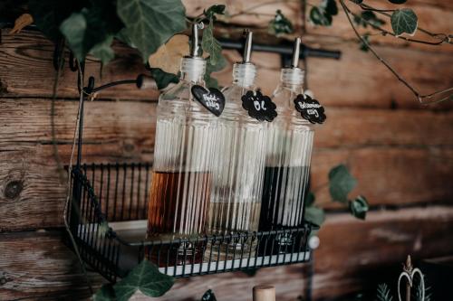 a group of four glass bottles on a rack at Alpenappartements Cristall in Ehrwald