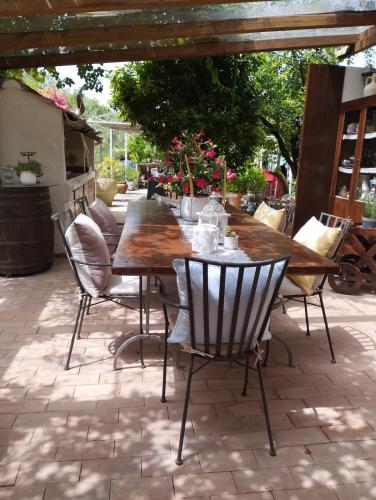 a wooden table and chairs on a patio at Petalo Rosso b&b in Lenola