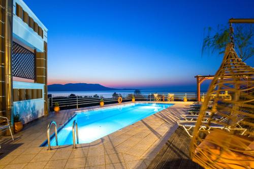 a swimming pool with a view of the ocean at Ben's Homes in Nopíyia
