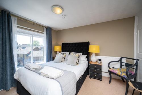 a bedroom with two beds and a window at The Bramley House Hotel in Chatteris