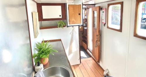 a kitchen with a sink in a tiny house at Unique Boat Accomodation - Fjælstavn - Bornholm in Hasle