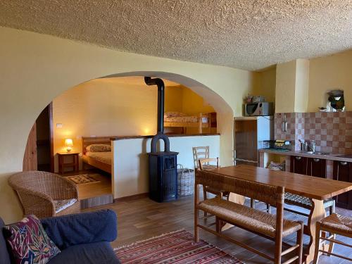 a kitchen and living room with a table and a stove at Agriturismo Giandriale in Tavarone
