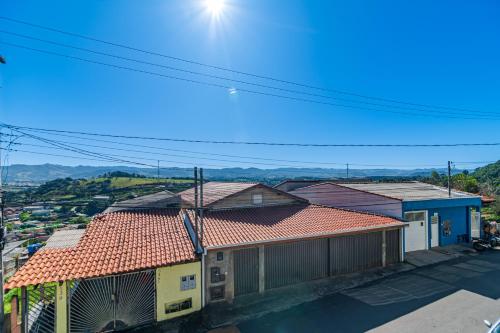 a group of houses with roofs on a street at Pousada Casa da Cidinha in Extrema