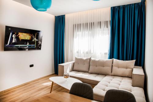 a living room with a couch and a table at Magdalena Suite 3.0 in Heraklio Town