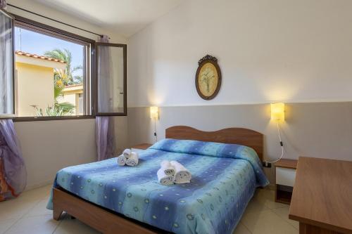 a bedroom with a bed with two towels on it at Delux ap15 in Mazara del Vallo