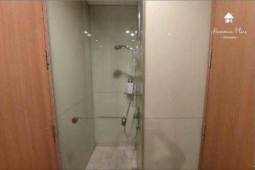 a shower stall with a glass door in a bathroom at 5mins to KLCC -Lvl32-2br-FreeParking in Kuala Lumpur