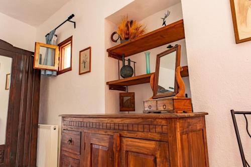 a mirror on top of a wooden dresser in a room at MaciliaVilla. in Ierápetra