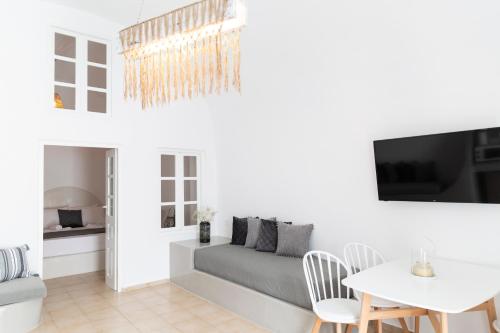 a living room with a couch and a table at Captain's house suites in Vóthon