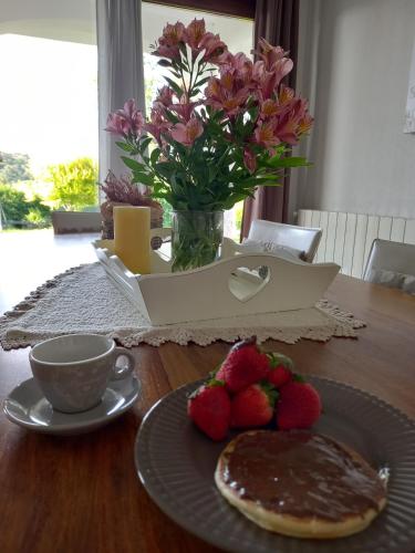 a table with a plate of chocolate cake and strawberries at Casa Orchidea in Aggius