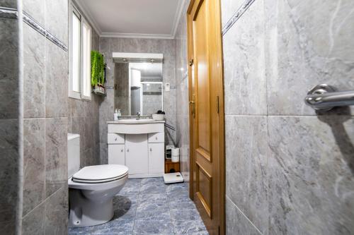 a bathroom with a toilet and a sink at Awesome apartment center Valencia in Valencia