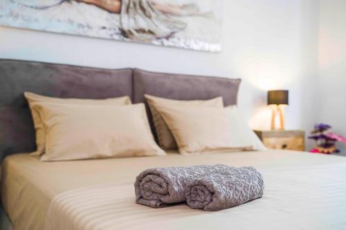 a large bed with a knitted blanket on it at Luxury rooms Alice in Split