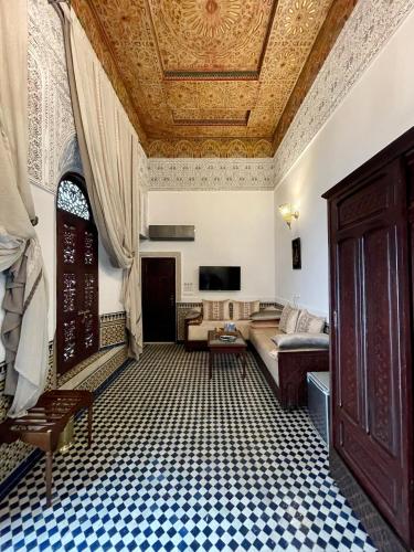 a living room with a couch and a ceiling at Le Grand Alcazar - Riad in Fès