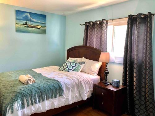 a bedroom with a bed with a dog laying on it at The Ultimate Escape. Unpack, Relax, Enjoy!Sleeps14 in Elmhurst