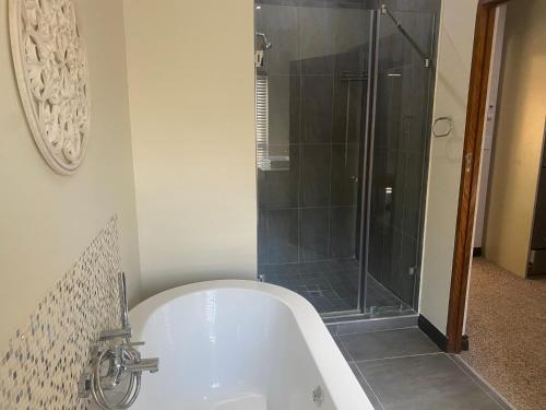 巴莉斯的住宿－Riverfront Golf Estate House，设有带浴缸和淋浴的浴室。