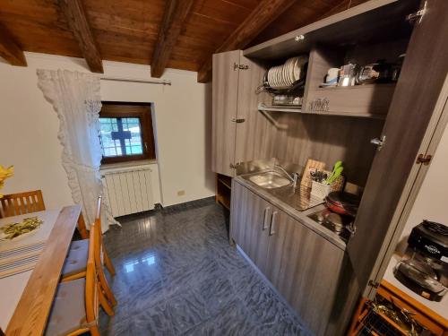 a kitchen with a counter and a table in it at Country house Dolce Nocciola in Vignanello