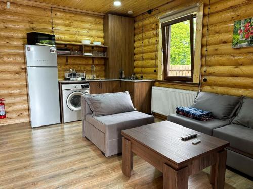 a living room with a couch and a table at Eco House Borjomi in Borjomi