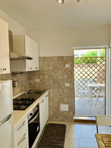 a kitchen with a sink and a stove top oven at Mini villino Ladispoli Centro Mare in Ladispoli